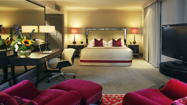 Red Sofa Set And White Bed In Room